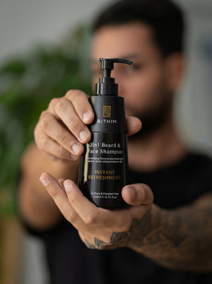 Person holding a black 2-in-1 beard and face shampoo bottle with 'Rithim' branding.